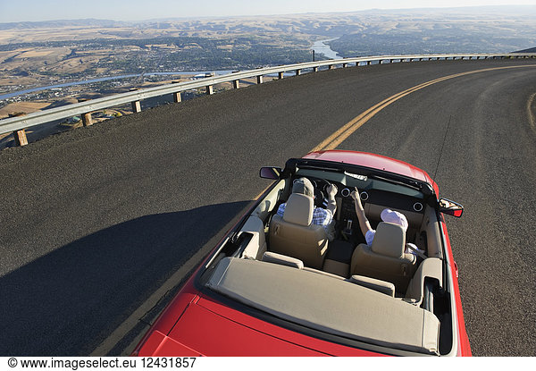 Young Caucasian couple on a road trip in their convertible sports car near Lewiston  Idaho USA.