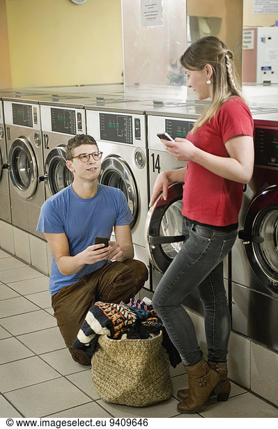 Young couple are changing mobile numbers  smiling