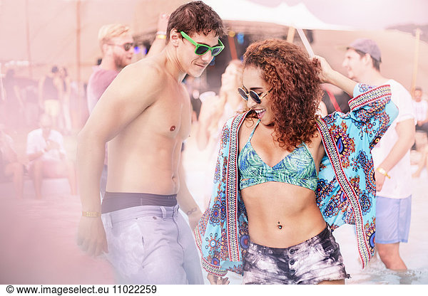 Young couple dancing at music festival