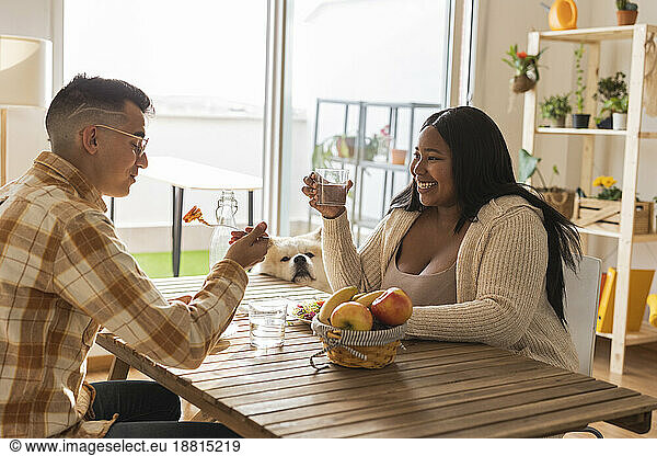 Young couple enjoying breakfast at dining table