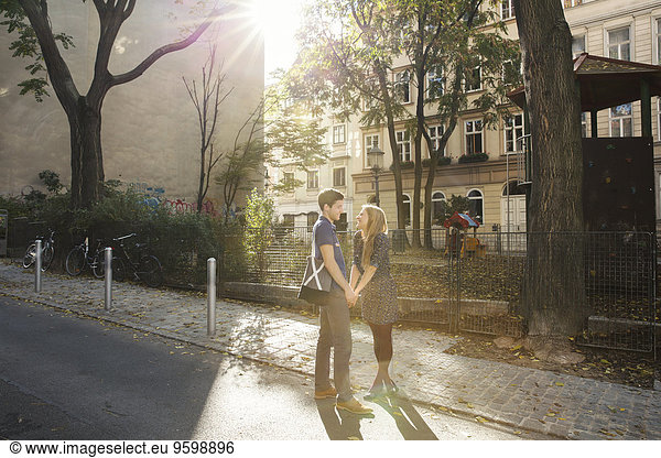 Young couple face to face on suburban street