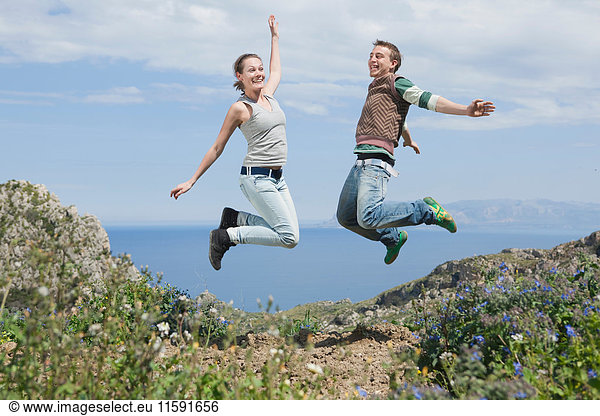 young couple jumping in air