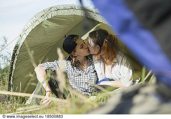 Young couple kissing in a camp  Bavaria  Germany