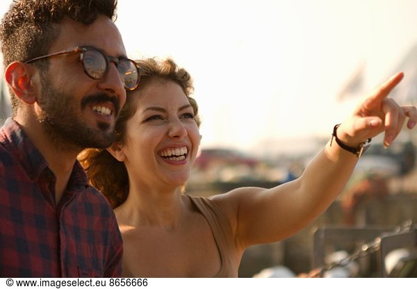 Young couple laughing  woman pointing