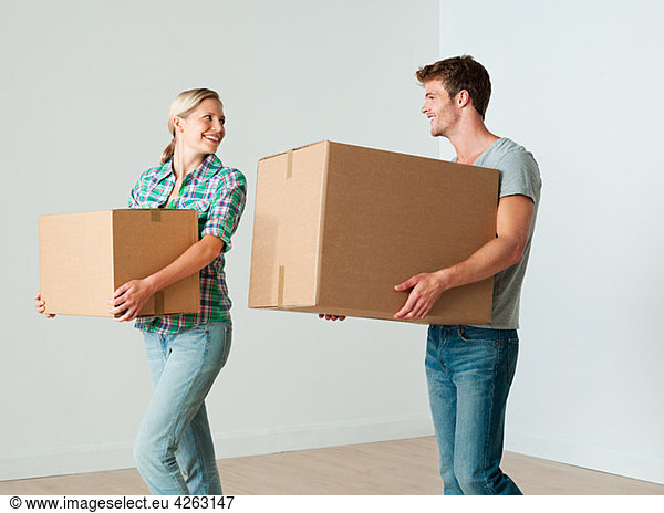 Young couple moving boxes