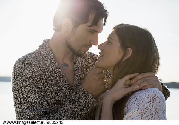 Young couple romantic sunset embracing