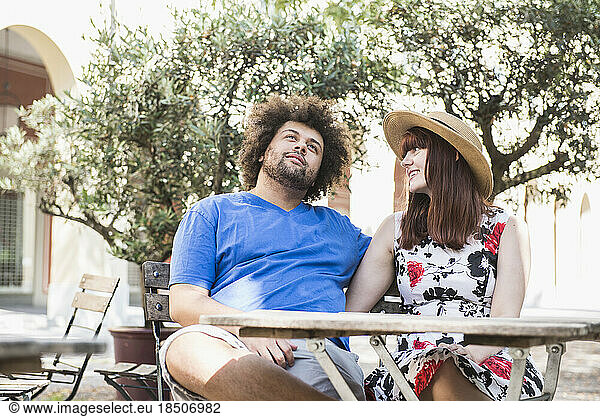 Young couple sitting at outdoor restaurant