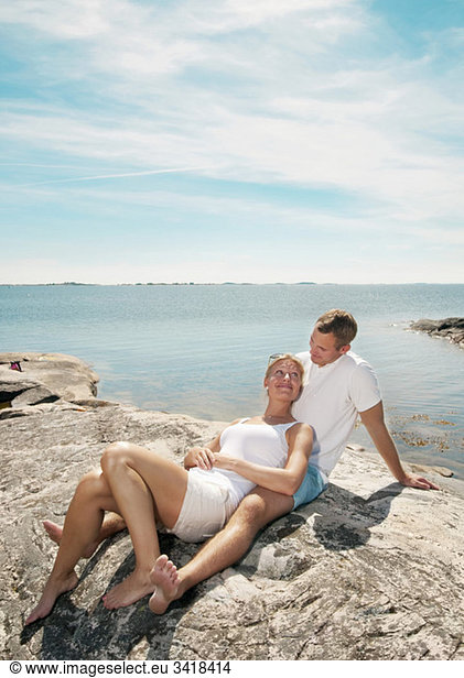 Young couple sitting on the beach
