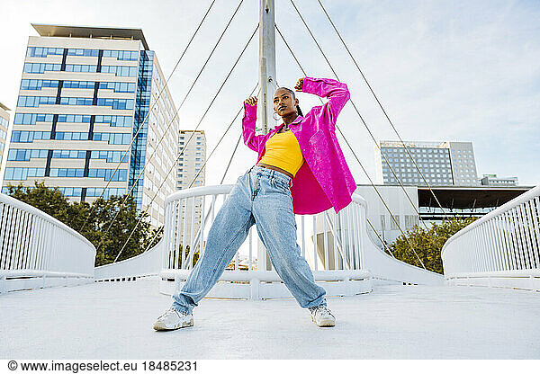 Young dancer breakdancing on bridge