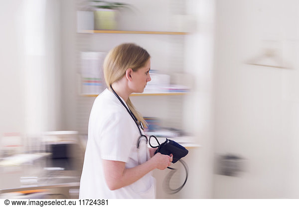 Young doctor in examination room in motion