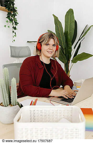 Young entrepreneur with headphones at creative office