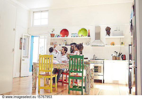Young family playing in kitchen