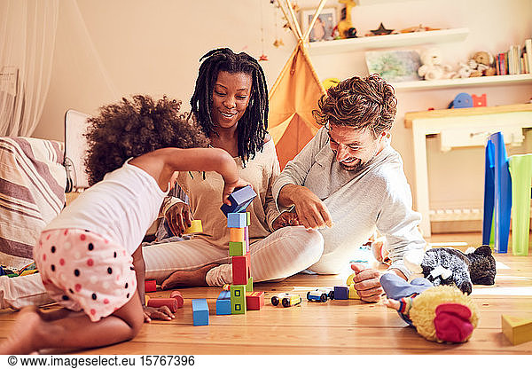 Young family playing with wood blocks