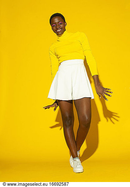 young fashionable woman  total yellow style on yellow background