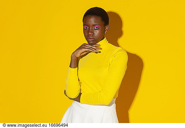 young fashionable woman  total yellow style on yellow background
