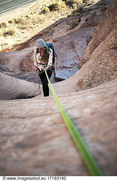 Young female canyoneering on mountain