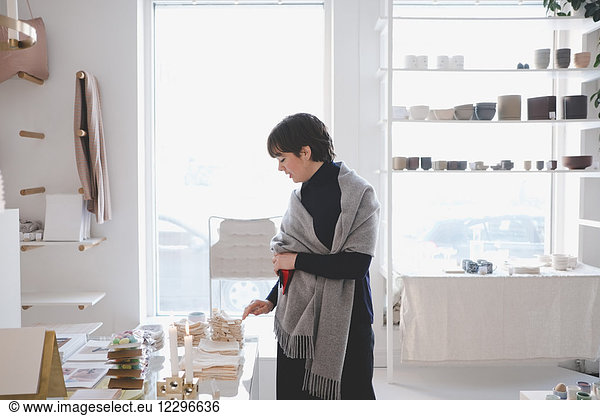 Young female customer examining swatches in store