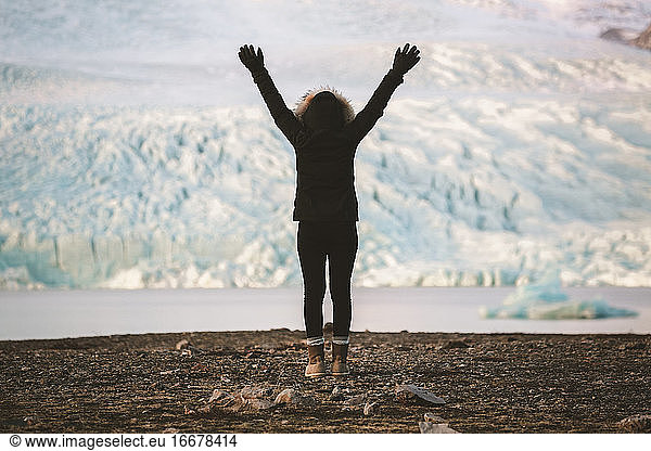 Young female enjoying view in front of Icelandic glacier lagoon