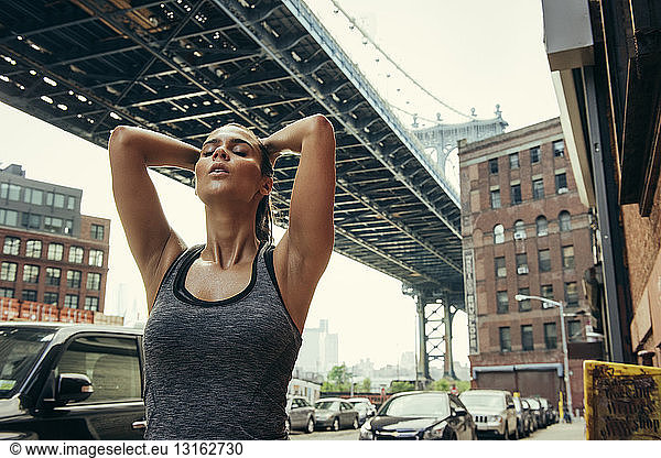 Young female runner taking a break  New York  USA