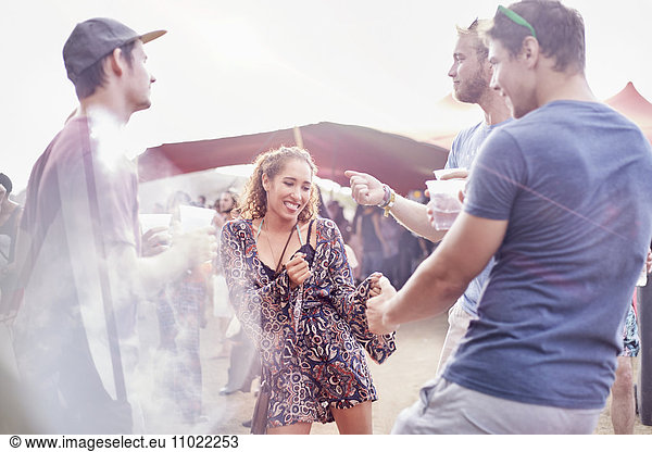 Young friends dancing at music festival