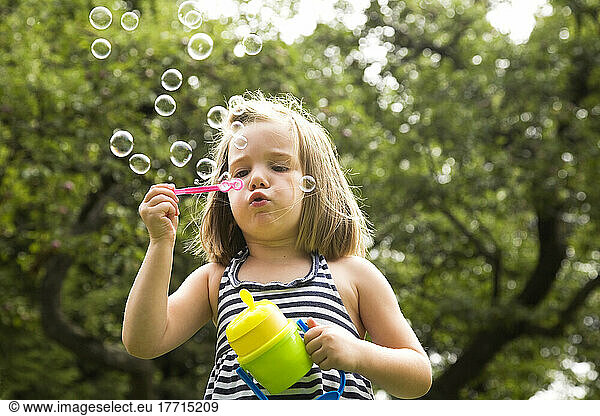 Young Girl Blowing Bubbles; Ontario Canada