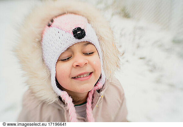 Young girl child happy in snow smiling