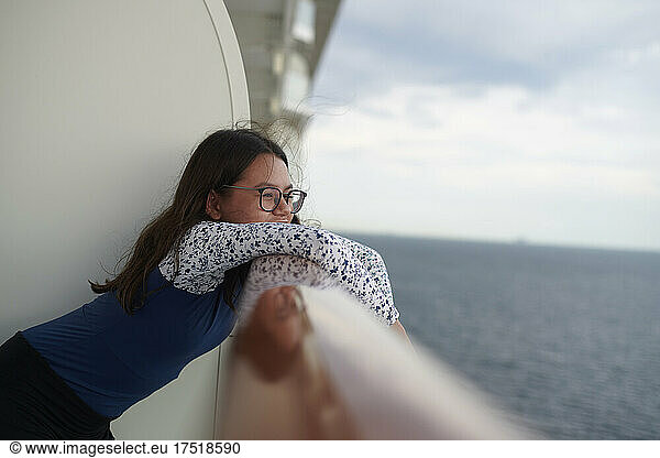 Young girl enjoying balcony view on cruiseship