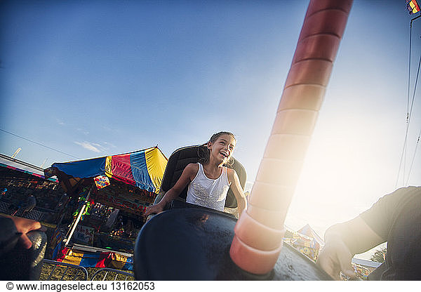 Young girl enjoying fairground ride