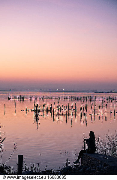 Young girl enjoying the sunset at Valencia Albufera against the light