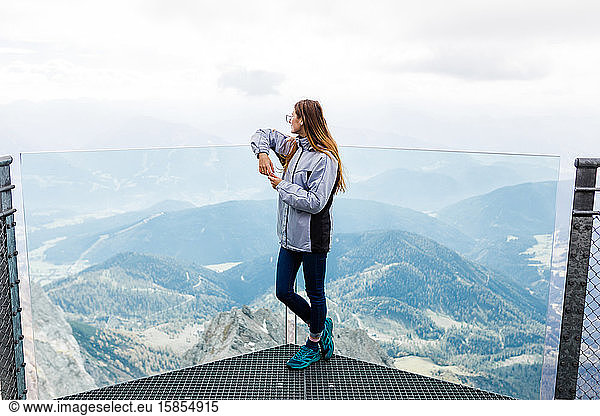 young girl enjoys the views of the Alps from the observation deck