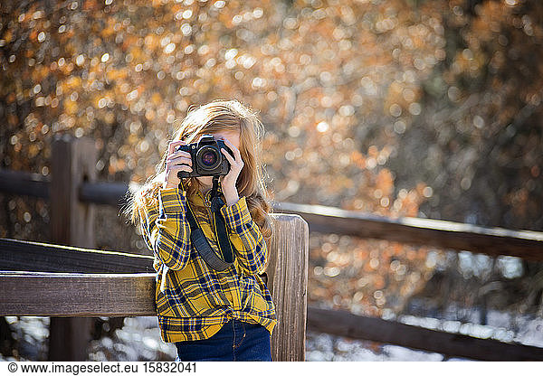 Young Girl Hiking and Taking Pictures in the Mountains