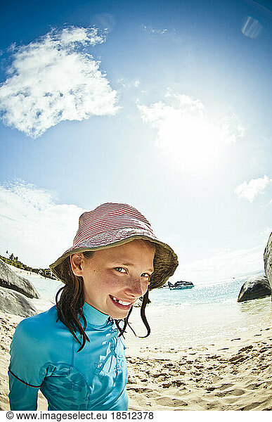 Young girl in hat on the beach.