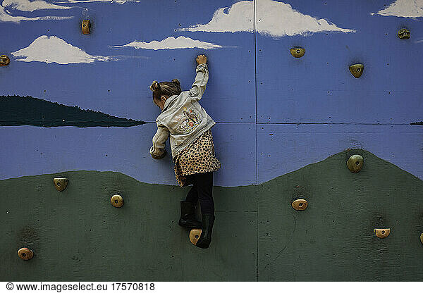 Young girl on climbing wall