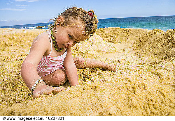 young girl playing in sand  Cabo San Lucas  Mexico