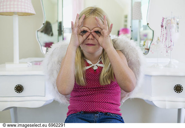 Young Girl Playing Peek-a-Boo with Her Fingers