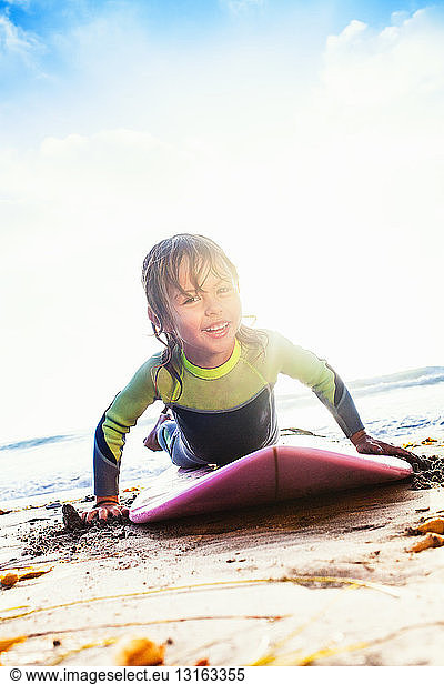 Young girl practicing surfing on beach  Encinitas  California  USA
