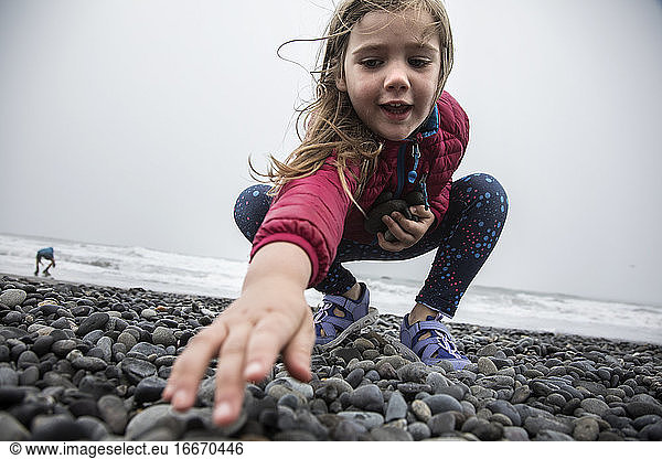 Young Girl Searches for Skipping Rocks