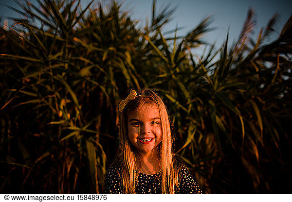 Young Girl Smiling at Camera During Sunset