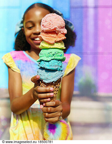 Young girl smiling while eating rainbow ice cream in Virginia