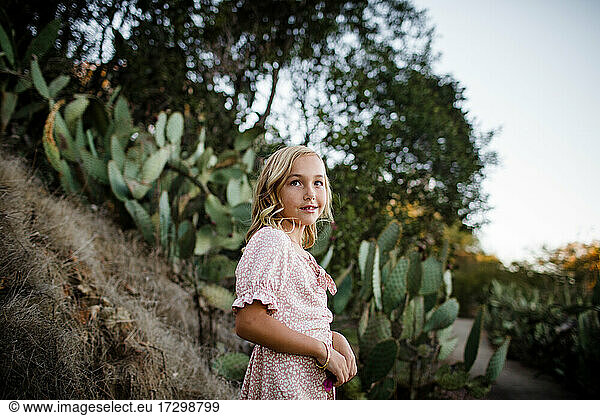 Young Girl Standing in Desert Garden in San Diego