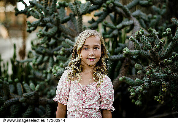 Young Girl Standing in Front of Cactus in San Diego