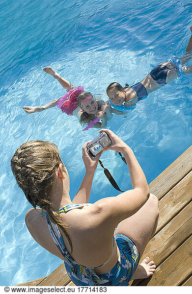 Young Girl Taking Photos Of Her Friends In A Swimming Pool  Victoria  British Columbia