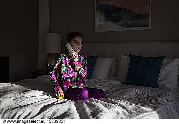 Young Girl Talking on Phone in Bedroom