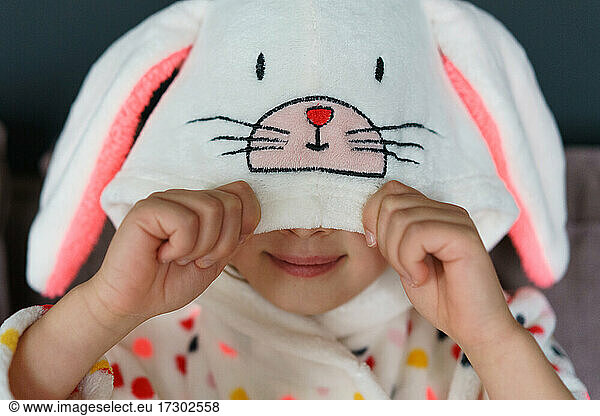 Young girl wearing Easter bunny robe.