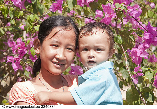 Young girl with a small child in her arms  Phu Quoc  Vietnam  Asia