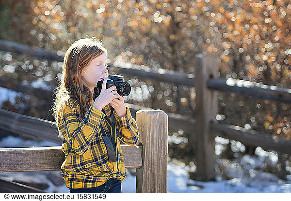 Young Girl With Camera Hiking in the Mountains