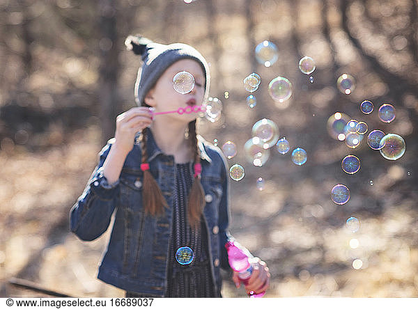 Young Girls Blowing Bubbles Outdoors