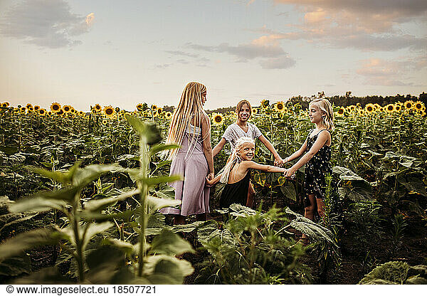 Young girls dancinig in a sunflower field in northwest Indiana