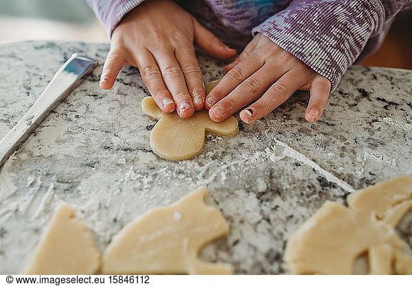 Young girls hands on cookie dough cut out