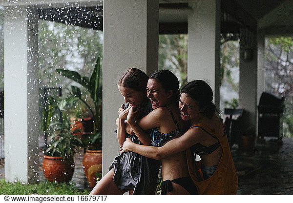 Young girls laugh as thunder cracks during a tropical storm